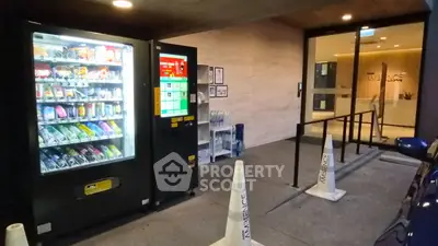 Modern building entrance with vending machine and sleek design
