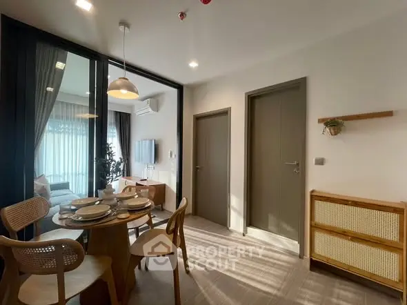 Modern dining area with natural light and stylish furniture in a cozy apartment.