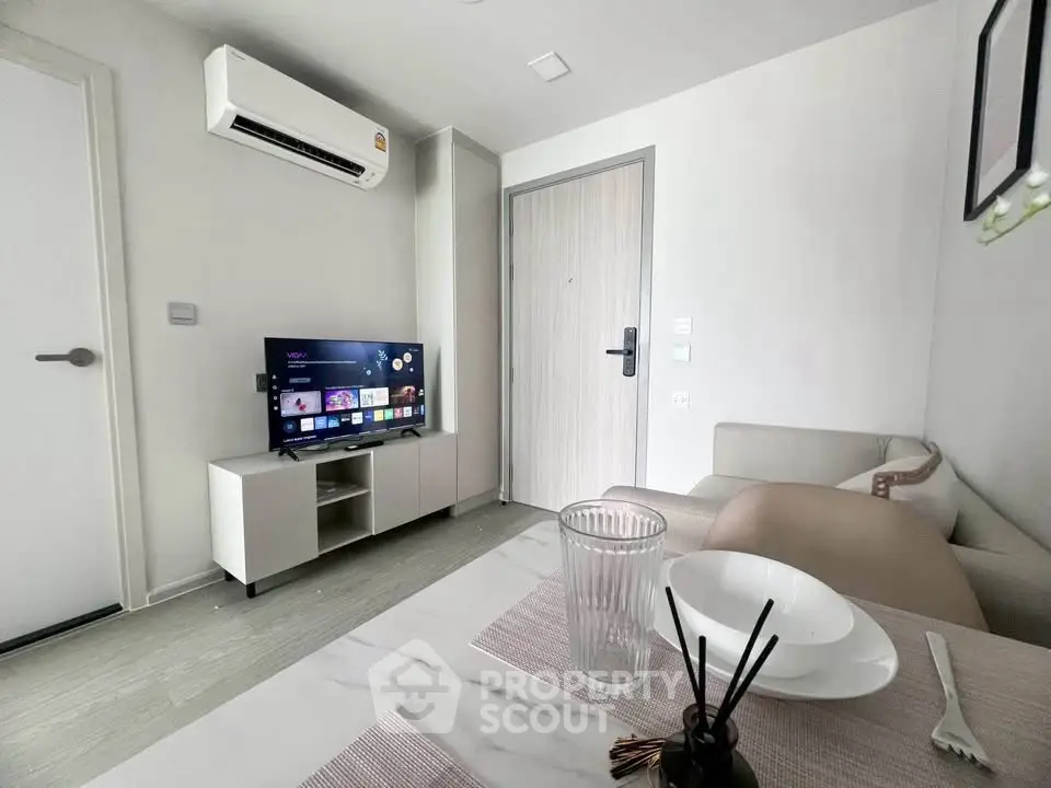 Modern living room with air conditioning and smart TV in a cozy apartment.