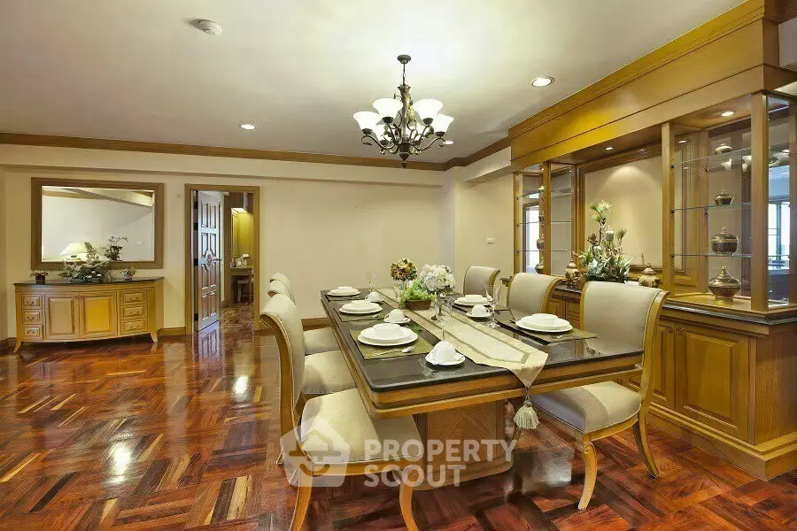 Elegant dining room with wooden flooring and classic chandelier, perfect for family gatherings.