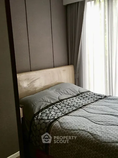 Cozy bedroom with elegant decor and large window for natural light