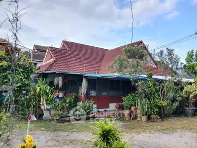 Charming suburban house with lush garden and red-tiled roof, perfect for nature lovers.