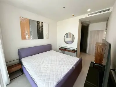 Modern bedroom with stylish decor and large bed in a bright apartment.