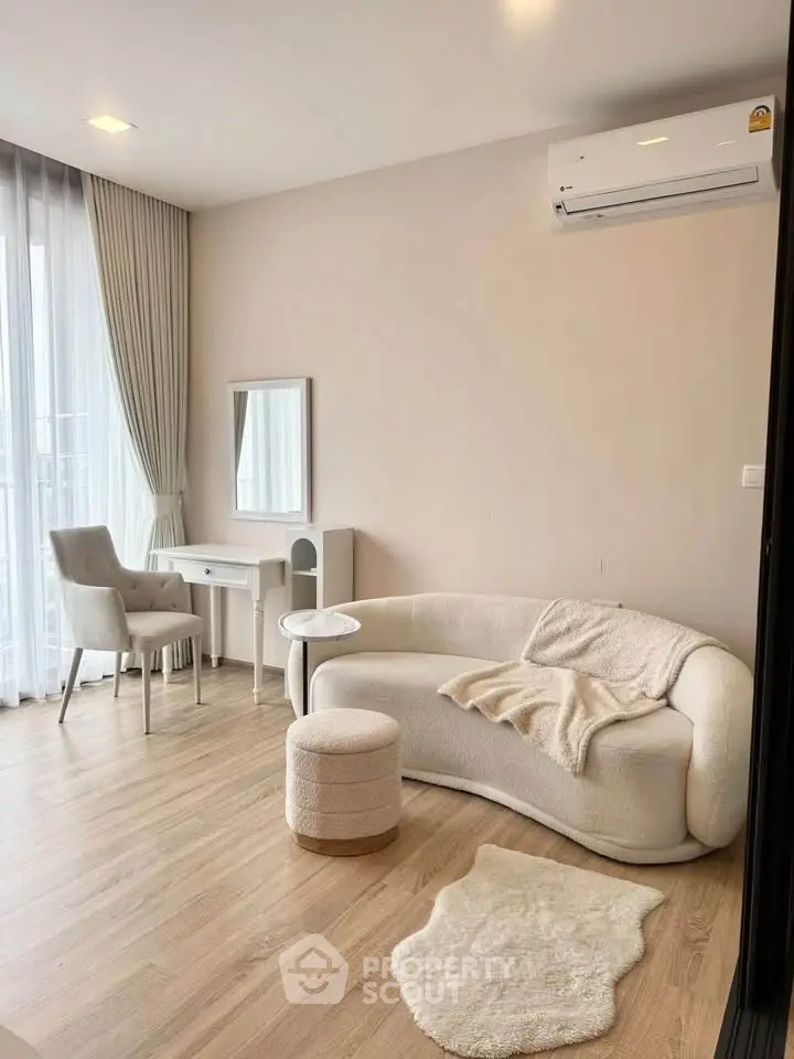 Elegant living room with modern furniture and natural light, featuring a cozy sofa and stylish decor.