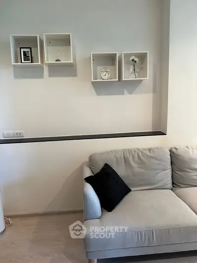 Modern living room with stylish wall shelves and cozy sofa