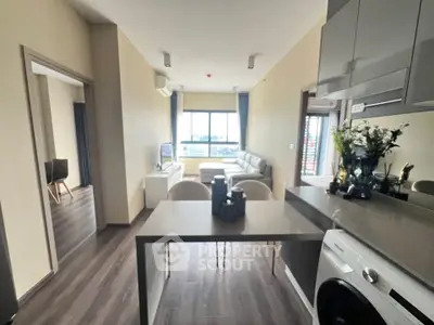 Modern open-plan living room with sleek kitchen and city view