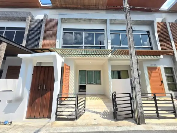 Modern townhouse exterior with sleek design and large windows