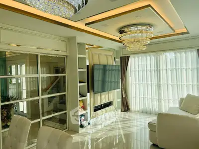 Luxurious living room with elegant chandeliers and floor-to-ceiling windows