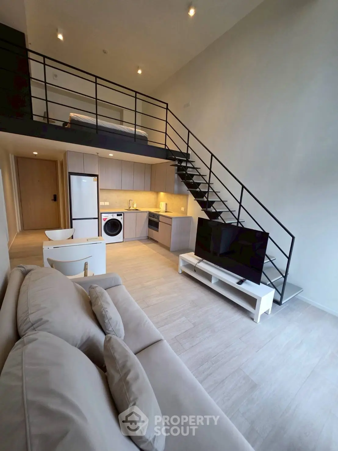 Modern loft apartment with open kitchen and stylish staircase