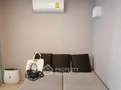Modern living room with air conditioning and stylish sofa, perfect for relaxation.