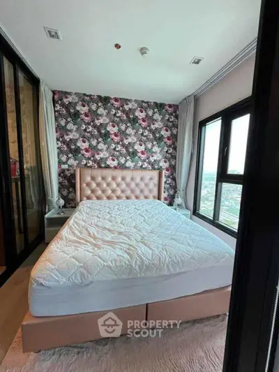 Luxurious bedroom with floral accent wall and panoramic city view
