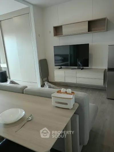 Modern living room with sleek furniture and TV, open layout design, perfect for cozy gatherings.