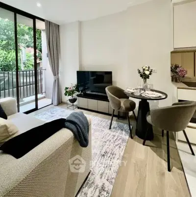 Modern living room with stylish decor and balcony view, perfect for urban living.