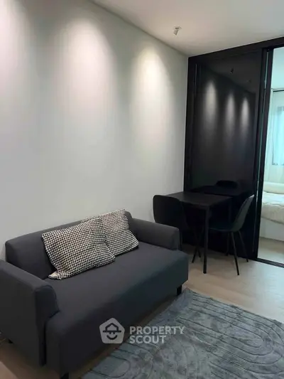 Modern living room with sleek sofa and dining area in stylish apartment