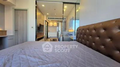 Modern bedroom with stylish decor and large windows for natural light