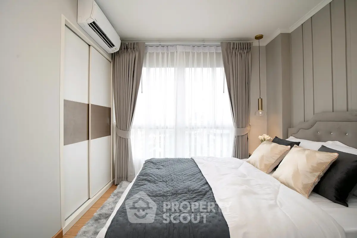 Elegant bedroom with stylish decor and natural light, featuring a cozy bed and modern wardrobe.