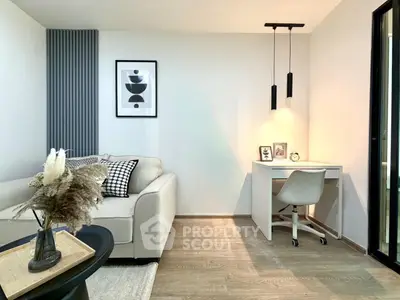 Modern living room with cozy sofa and stylish workspace, perfect for urban living.
