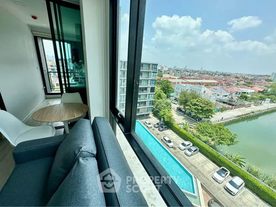 Stunning corner unit with panoramic city and pool views, featuring a cozy living area and modern furnishings.