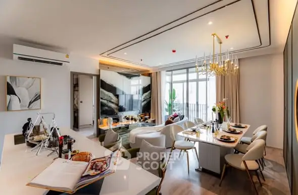 Luxurious open-plan living and dining area with modern decor and elegant lighting.