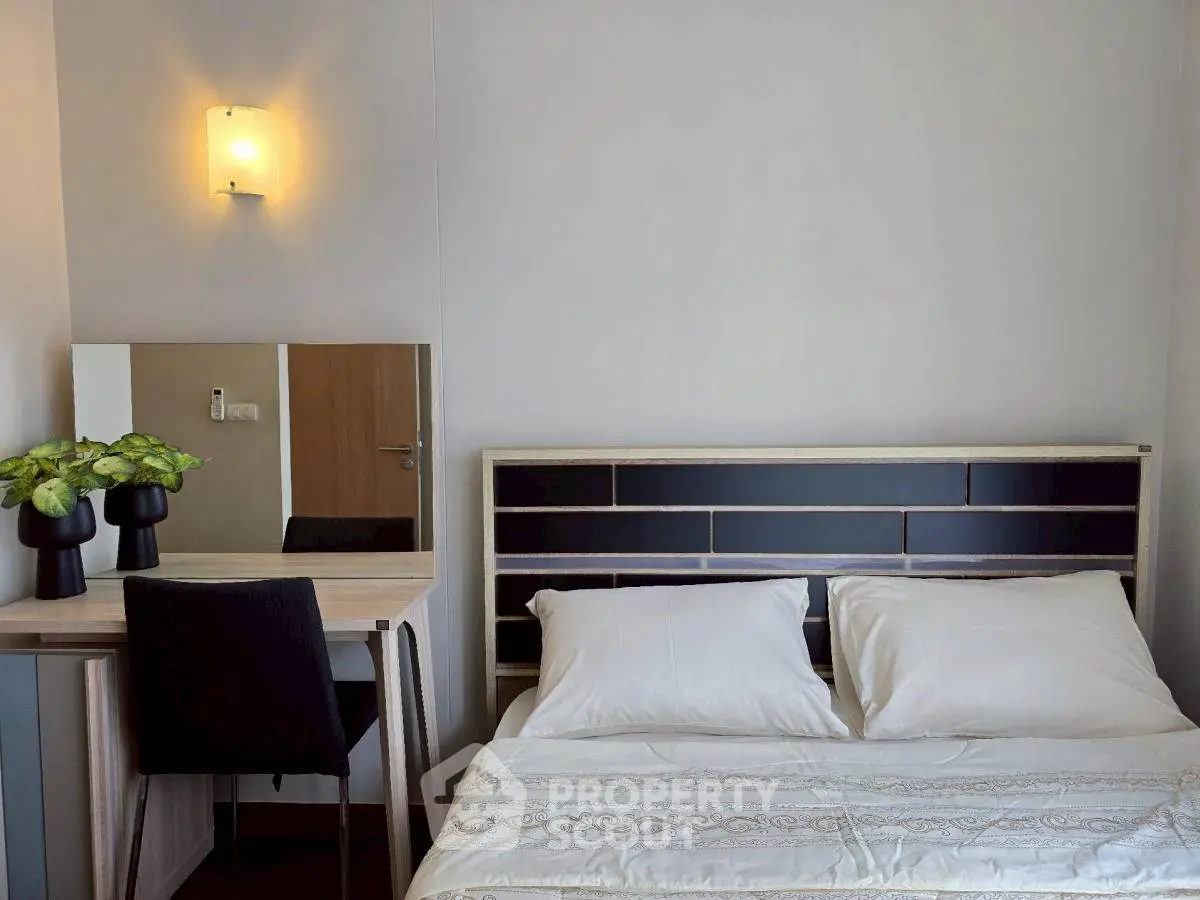 Cozy bedroom with modern decor and elegant lighting, perfect for relaxation and comfort.