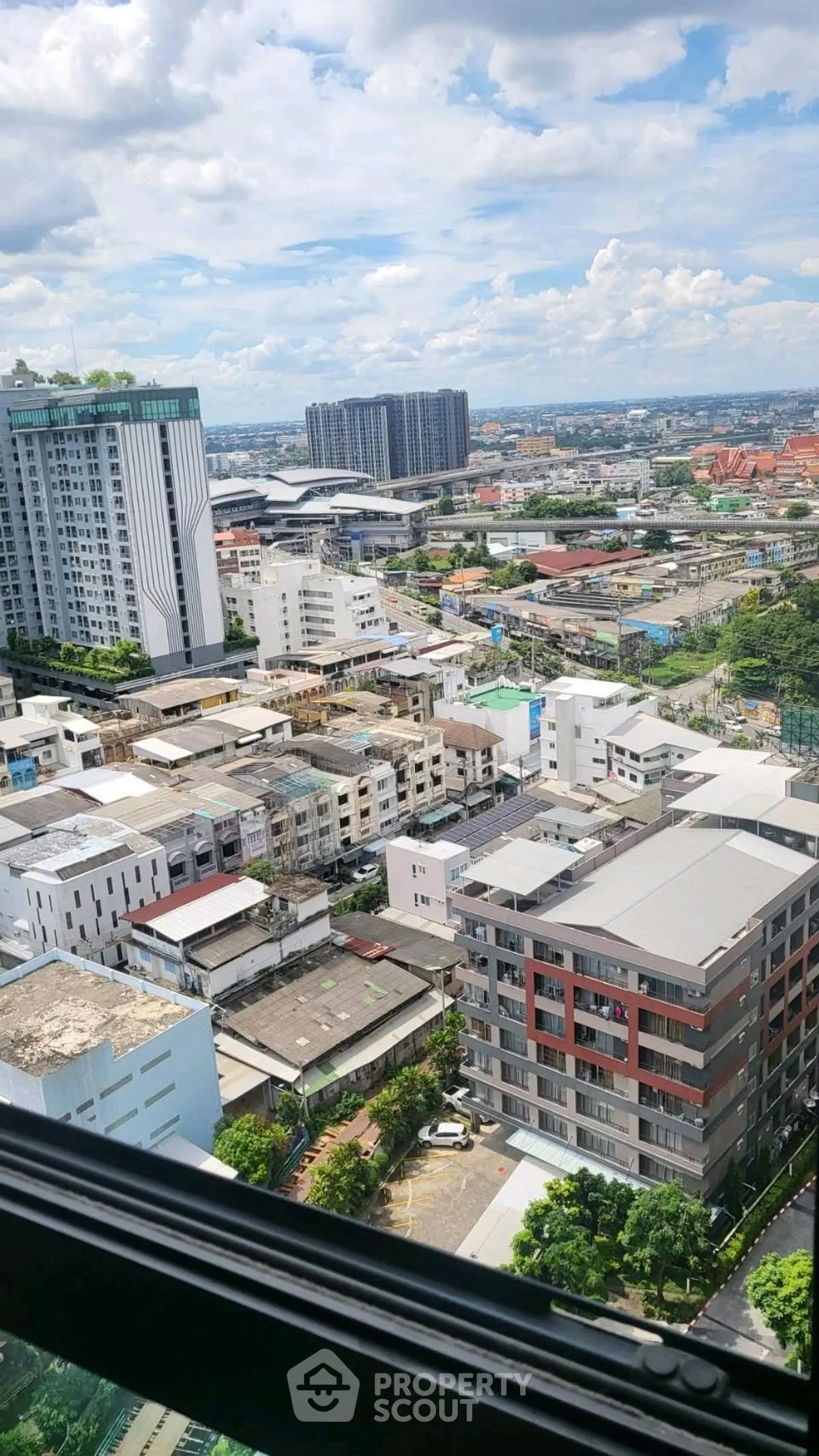 Stunning cityscape view from high-rise building window, showcasing urban architecture and skyline.