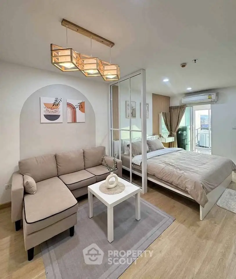 Modern studio apartment with cozy living area and stylish decor