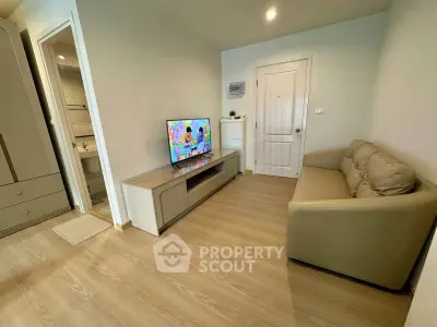 Cozy living room with modern TV setup and comfortable sofa in a stylish apartment.
