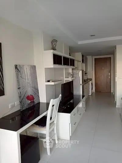 Modern apartment interior with sleek furniture and open layout, featuring a stylish living area and kitchen.