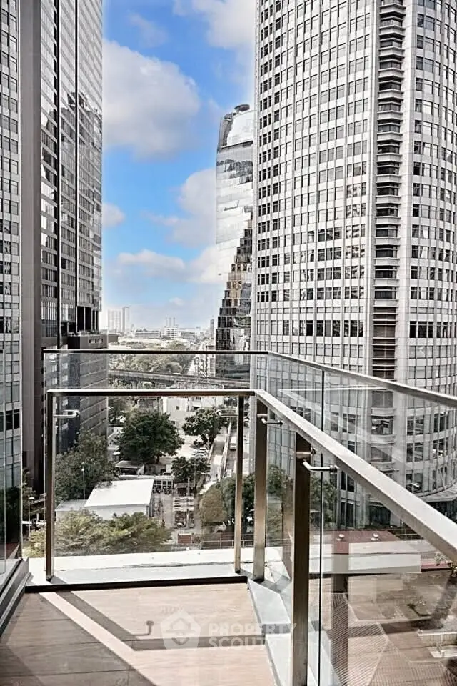Stunning cityscape view from a modern glass balcony in a high-rise building.