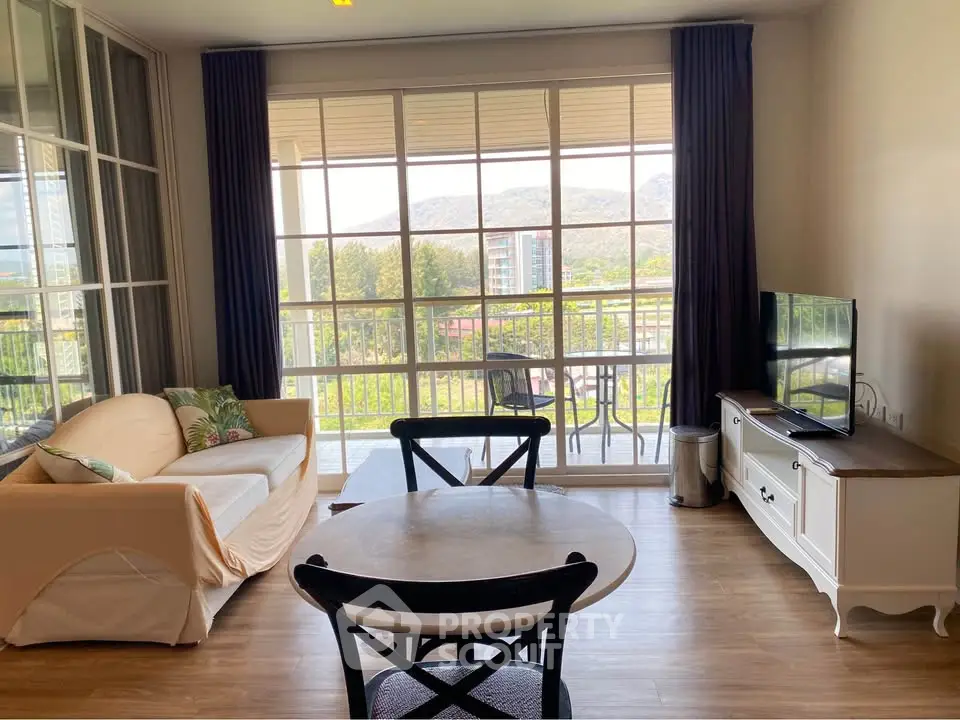 Charming living room with balcony view and elegant furnishings