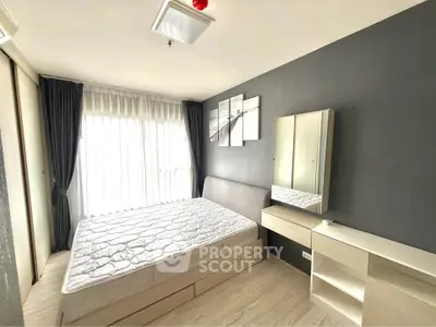 Modern bedroom with stylish decor and ample natural light in a contemporary apartment.
