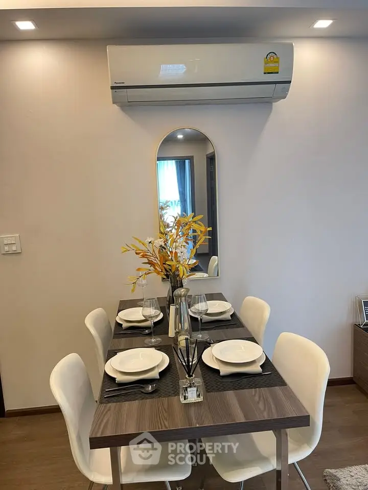 Modern dining area with elegant table setting and air conditioning