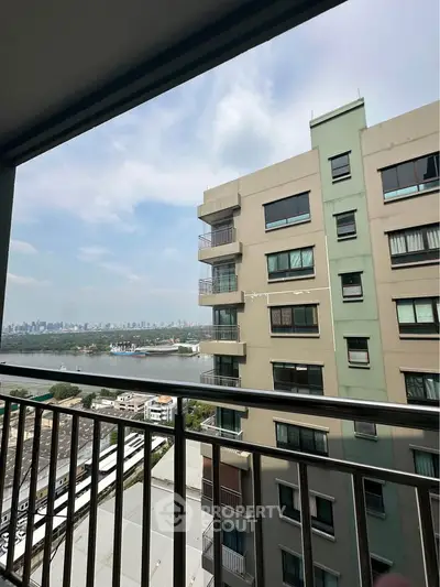Stunning city view from a high-rise balcony with modern railing.