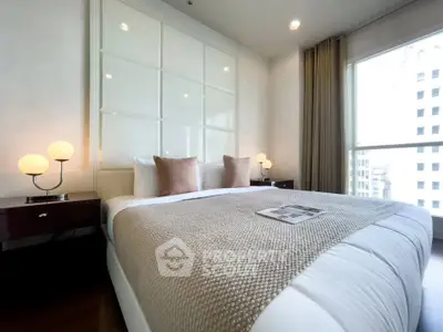 Luxurious bedroom with elegant decor and city view, perfect for urban living.