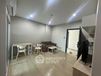 Modern living room with minimalist furniture and wooden flooring