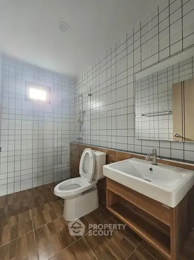 Modern bathroom with sleek fixtures and wooden accents