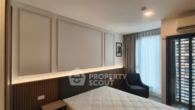 Modern bedroom with stylish decor and natural light, featuring a comfortable bed and elegant furnishings.