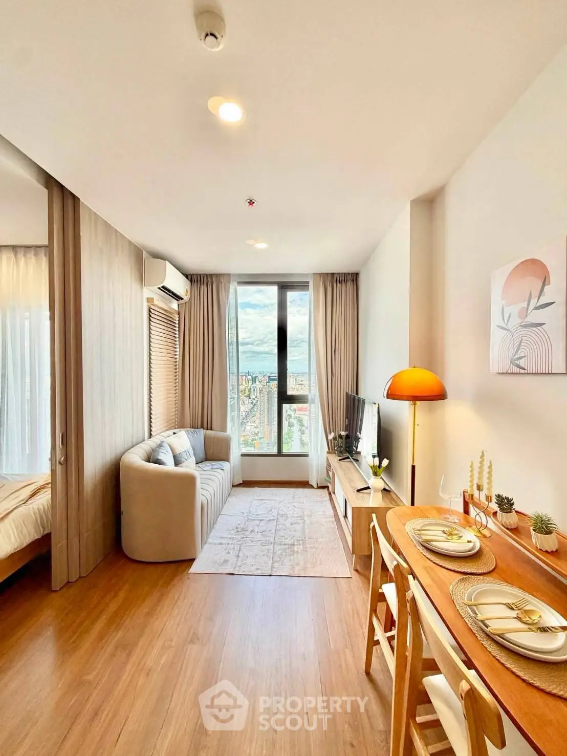 Chic modern living room with dining area and city view, perfect for urban lifestyle.