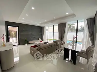 Spacious modern living room with pool view and elegant decor