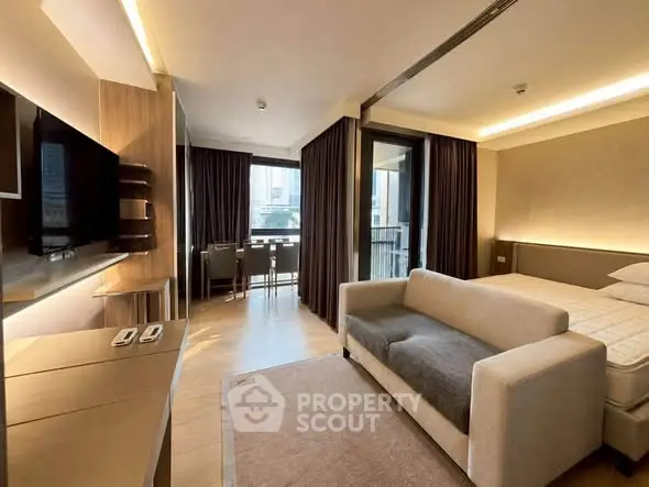 Modern studio apartment with cozy living area and balcony view