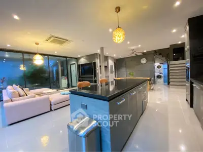 Luxurious open-plan living room with modern kitchen and stylish lighting