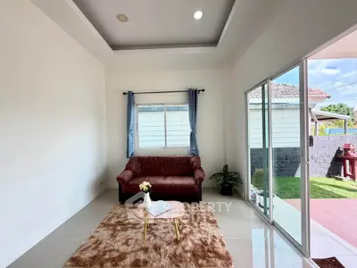 Charming living room with cozy sofa and garden view, perfect for relaxation and entertaining.