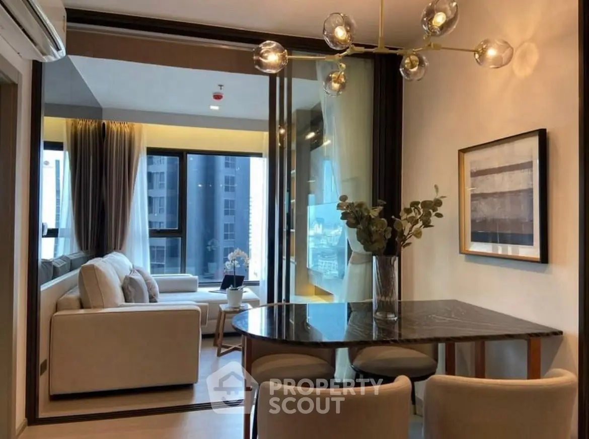 Modern living room with elegant decor and large windows in a stylish apartment.