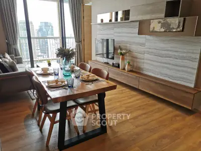 Modern living room with elegant dining area and city view, featuring stylish wooden flooring and contemporary decor.