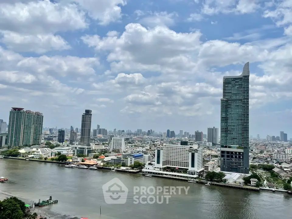 Stunning cityscape view with riverfront high-rise buildings under a vibrant sky.