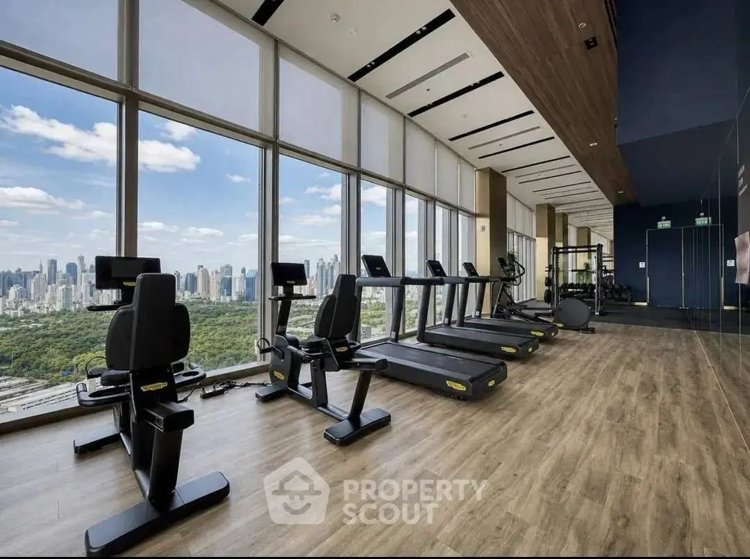 Luxurious high-rise gym with panoramic city views and modern fitness equipment.
