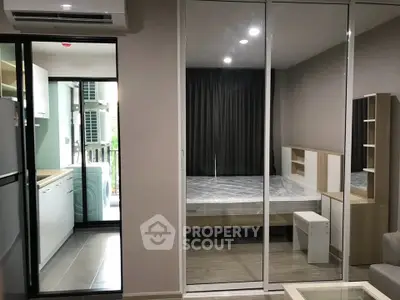 Modern apartment interior with mirrored wardrobe and cozy bedroom setup