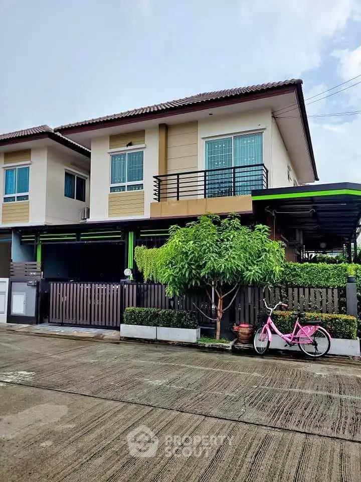 Charming two-story house with modern design and lush greenery in a serene neighborhood.