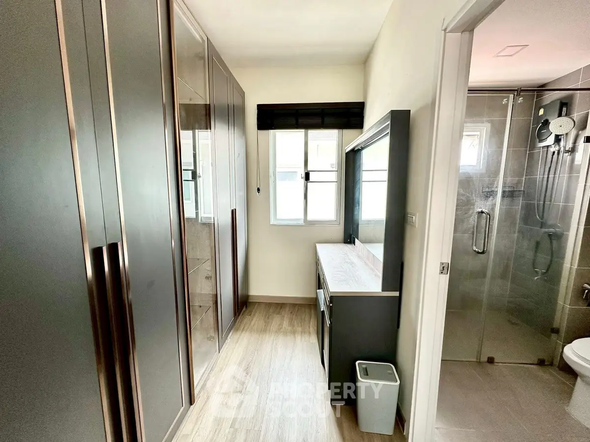 Modern bathroom with sleek cabinetry and glass shower enclosure