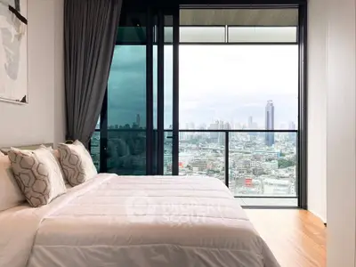 Luxurious bedroom with stunning city view from floor-to-ceiling windows in modern apartment.